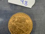 a close up of a gold coin with a label on it