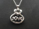 a silver necklace with a heart shaped pendant on it