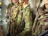 many mannequins dressed in military uniforms in a display case
