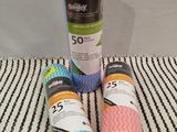 three rolls of toilet paper sitting on top of a striped towel