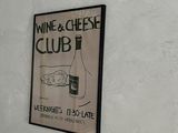 a sign on the wall that says wine and cheese club