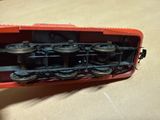 a red train car that is sitting on a table
