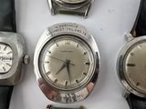several different types of watches are displayed on a white surface