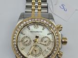 a close up of a watch on a white surface with a price tag
