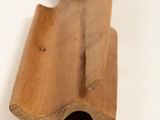 a wooden object on a white surface with a white background