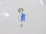 a white plate with a blue and green design on it