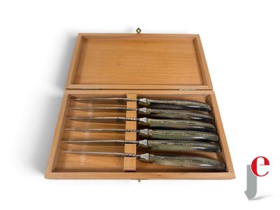 five knives in a wooden box on a white surface