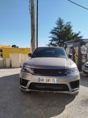 a silver car parked in front of a building