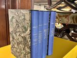 three books sitting on top of a yellow table