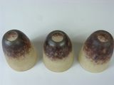 three salt and pepper shakers sitting on a white surface