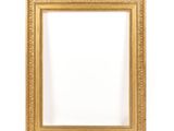 a gold picture frame hanging on a wall with a white background