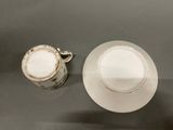 two cups and a saucer sitting on a table