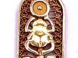 an image of a gold plated pendant with a picture of a boat on it