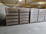 several pallets of plastic bottles are stacked on pallets in a warehouse