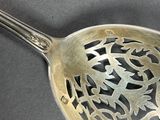 a silver spoon with a design on it on a table