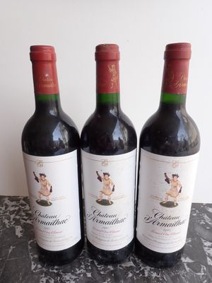 three bottles of wine sitting on top of a table next to each other