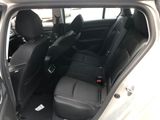 the back seats of a white car with black seats in it