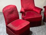 three red chairs sitting next to each other in a room