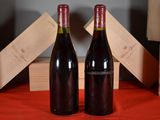 two bottles of wine sitting next to each other on a table