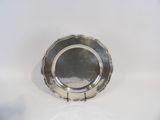 a silver plate on a white table with a white background