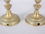 pair of antique brass candlesticks on a white background