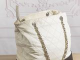 beige and black quilted tote bag with chain handles
