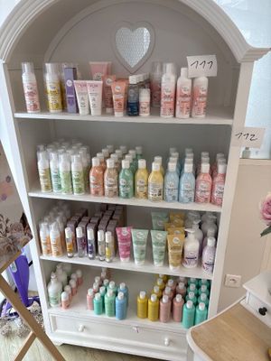 a white cabinet filled with lots of different types of body care products