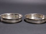 a pair of silver plated bowls with engraved designs
