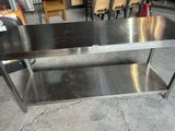 a stainless steel table with a shelf underneath it