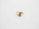 a gold ring with a green stone in the middle