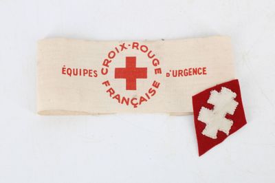 an old red cross patch on a white cloth with a red cross on it