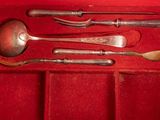 a red box with silverware in it on a red surface