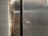 a stainless steel refrigerator in a kitchen with a glass door