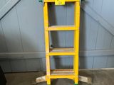 a yellow ladder that is leaning against the wall