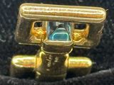 a gold ring with a blue stone inside of it