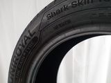 a close up of a tire on a table with a white background