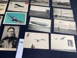 a lot of old photos of people and airplanes on the table