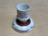 a small cup sitting on top of a saucer on a table