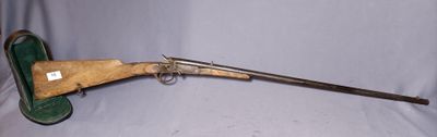 an old gun with a wooden handle and a green case