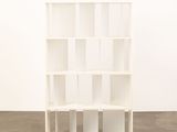 an image of a white bookcase in an empty room