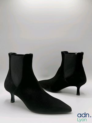 pair of black sued ankle boots on a white background