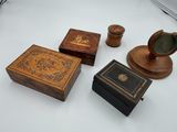four wooden boxes and a clock on a white table