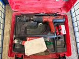 a red tool box with tools in it on the floor