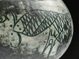 a black and white vase with a drawing of a fish on it