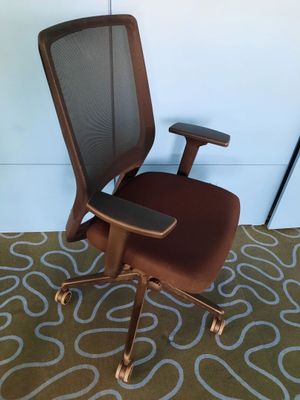 an image of a brown office chair sitting on top of a carpet