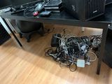 a computer desk with a lot of wires on it
