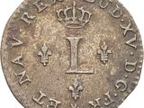 a silver coin with a crown on top of it