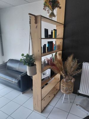 a room with a couch and a book shelf in it