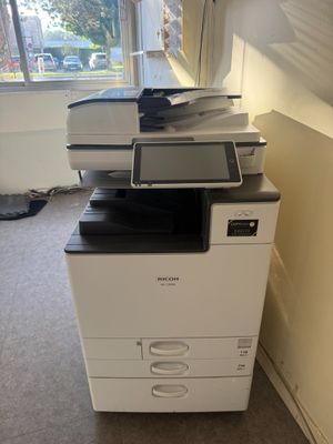a printer that is sitting on top of a cabinet