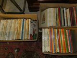 une boîte remplie de livres posée par terre à côté d'une table